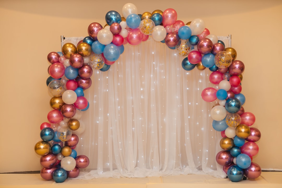 multicolored-balloon-arrangement-near-white-curtain-wrcgyrggzmw